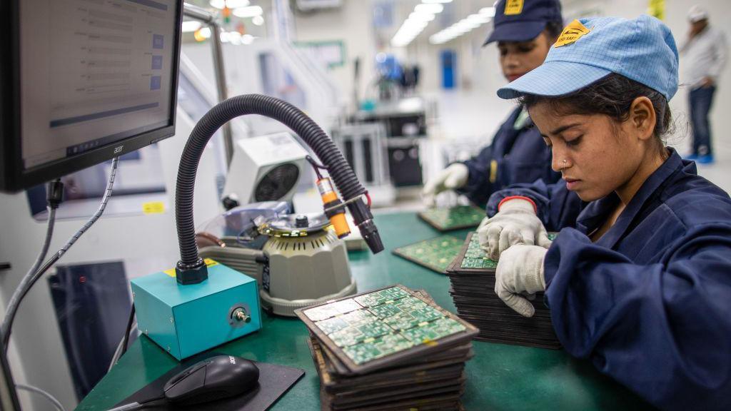 Employees work on the SMT (surface mount technology) shop floor where components are mounted on a PCB (printed circuit board) at Padget Electronics Pvt., a subsidiary of Dixon Technologies Ltd., in Noida, India.