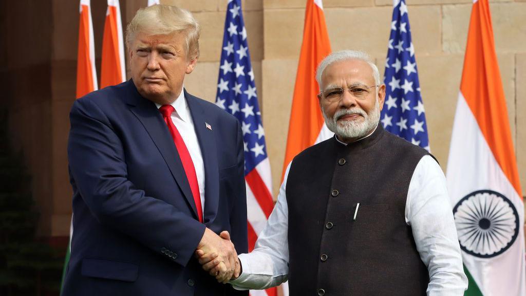 US President Donald Trump shakes hands with Indian Prime Minister Narendra Modi, as they pose for photographers at Hyderabad House in New Delhi, India, in February 2020.