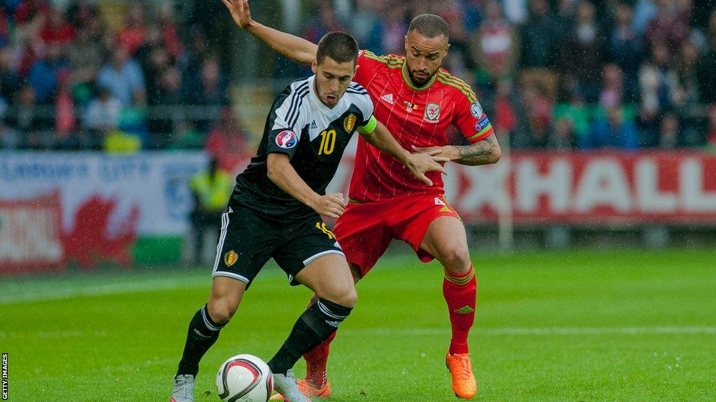 Jazz Richards and Eden Hazard compete for the ball