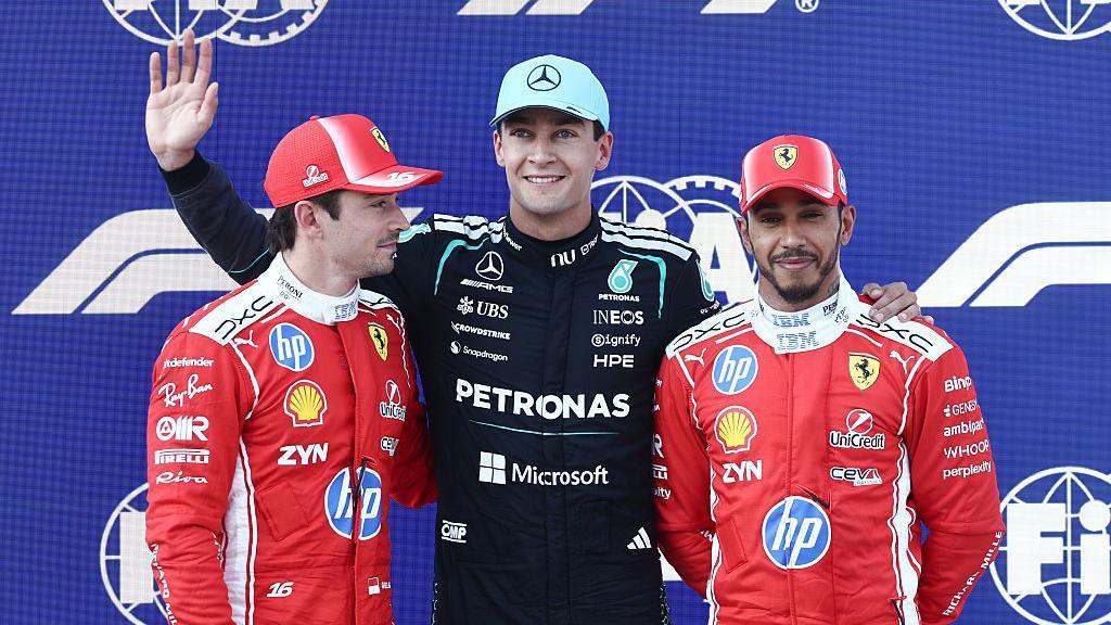 Charles Leclerc, George Russell and Lewis Hamilton pose for photos after qualifying 