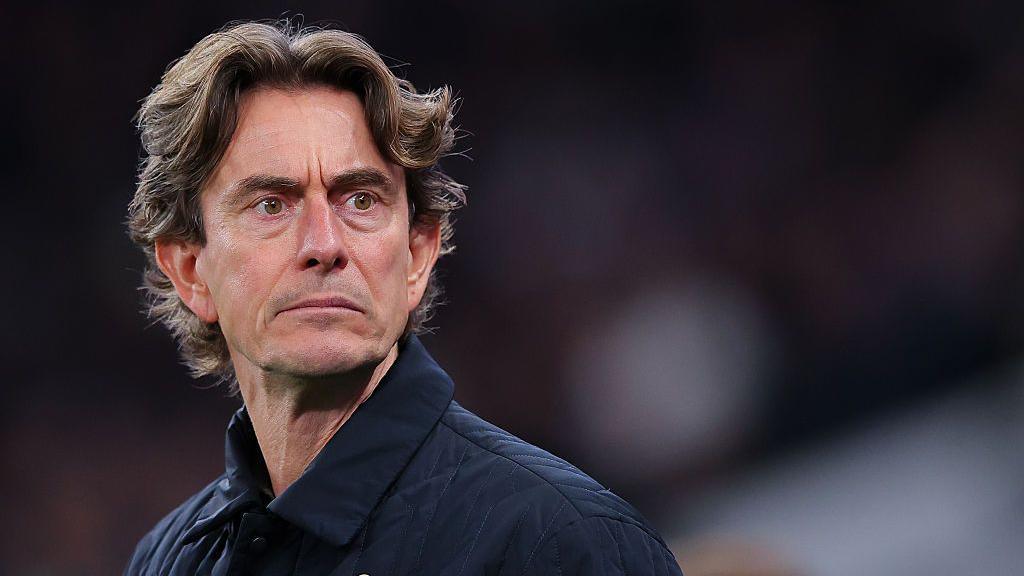 A photo of Spurs' manager Thomas Frank looking into the distance