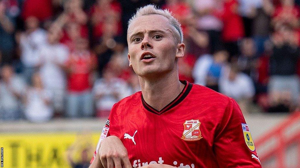 Harry McKirdy celebrates a goal for Swindon