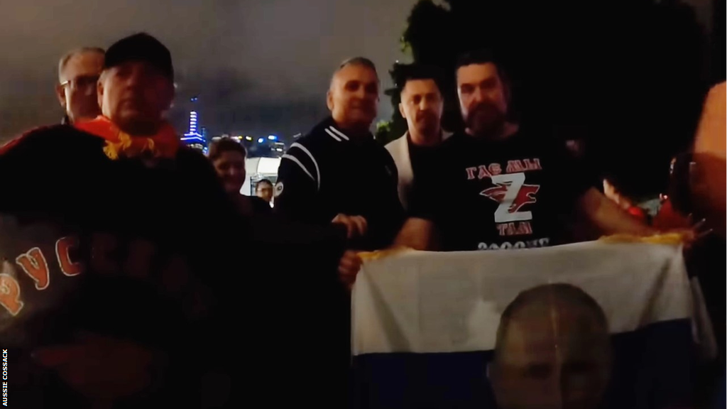 Novak Djokovic's father Srdjan is filmed posing for pictures with supporters of Russia president Vladimir Putin at the Australian Open.