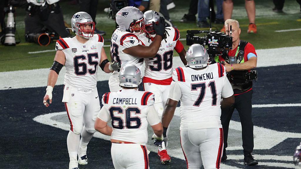 New England Patriots' running back Rhamondre Stevenson celebrates with teammates after scoring a touchdown during Super Bowl LX