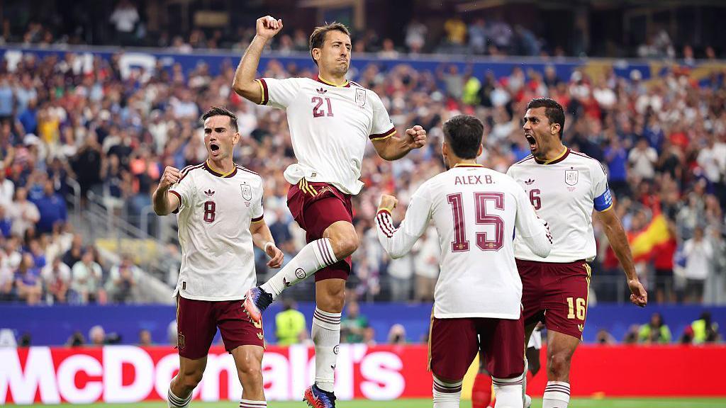Mikel Oyarzabal leaps in the air and pumps his fist in celebration