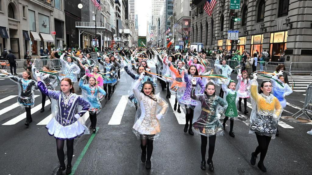 Hundreds of dancers take part in the New York City annual St Patrick's Day parade wearing colourful costumes 