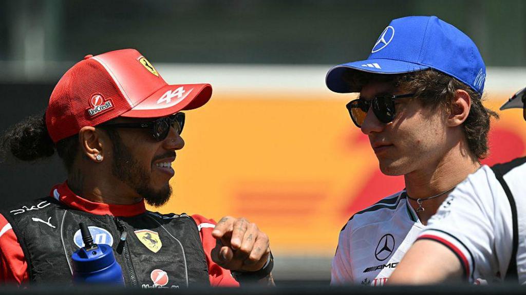 Ferrari's Lewis Hamilton and Mercedes' Kimi Antonelli in conversation during the drivers' parade before the Hungarian Grand Prix