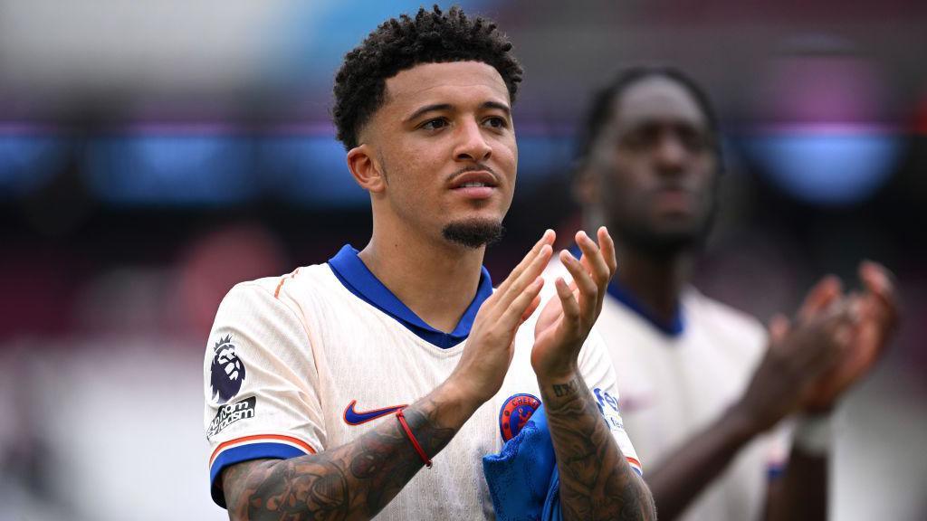 Jadon Sancho applauds the Chelsea fans after their win against West Ham.