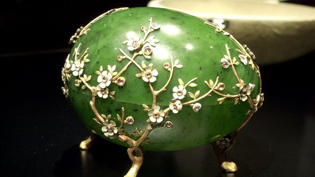 The Apple Blossom Easter Egg - a green Fabergé egg decorated with white flowers.