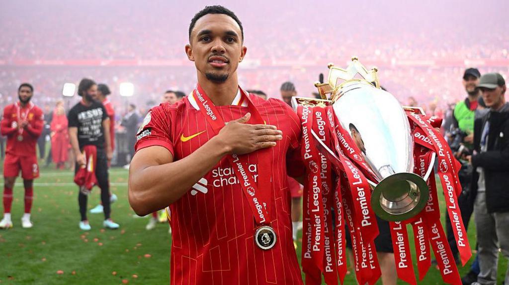 Trent Alexander-Arnold celebrates with the Premier League trophy