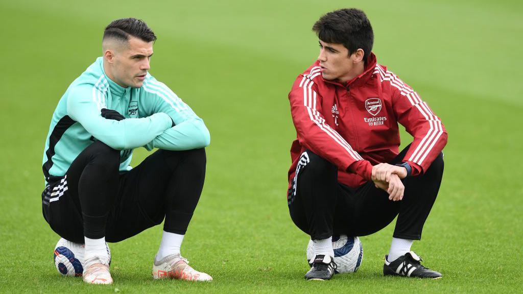 Arsenal assistant coach Carlos Cuesta with Granit Xhaka during a training session at London Colney on May 22, 2021 in St Albans, England