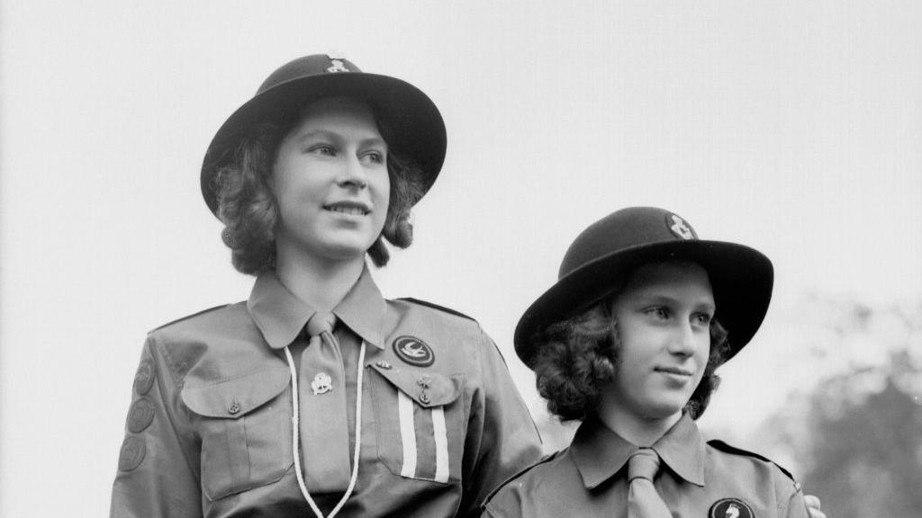 Princesses Elizabeth (left) and Margaret Rose wearing Girl Guide uniforms.