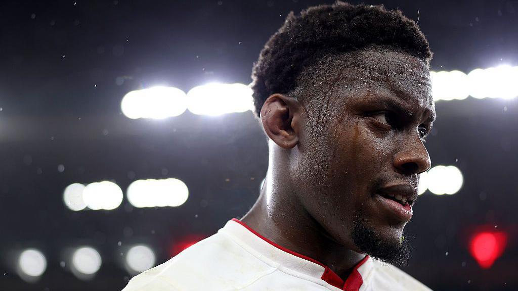 Maro Itoje looks on with sweat dripping down his face