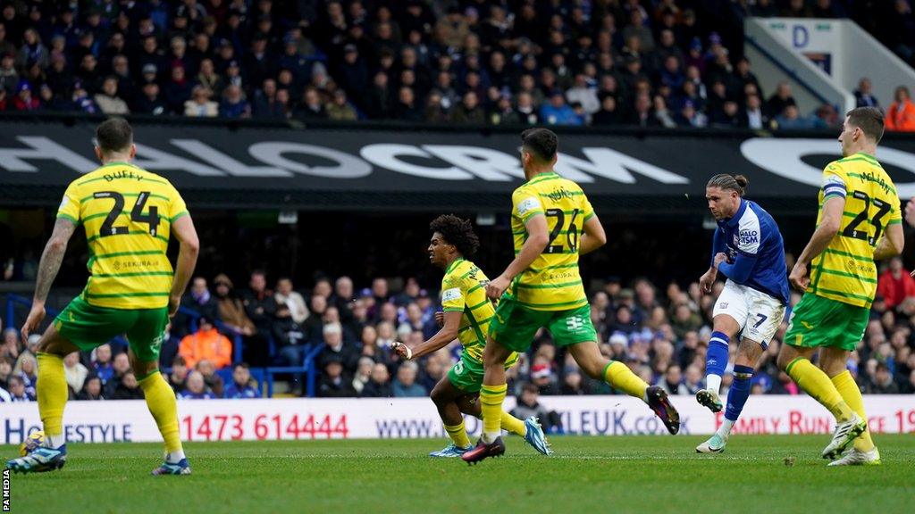 Wes Burns strikes the ball to score for Ipswich