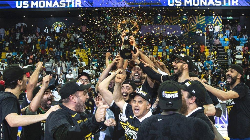 US Monastir players and staff celebrate with the Basketball Africa League trophy