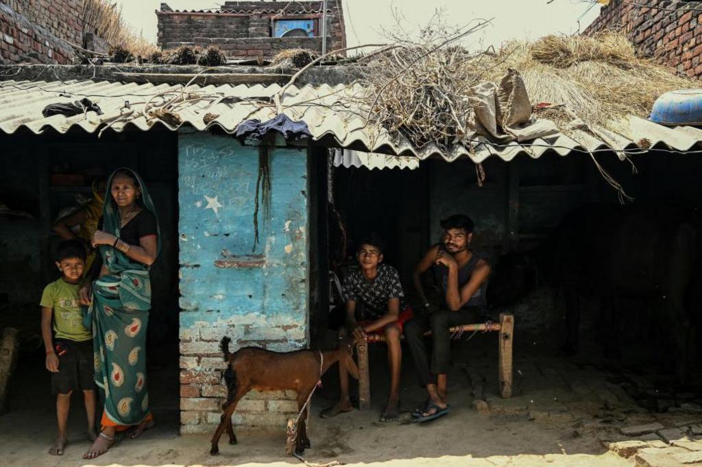 In this photograph taken on May 6, 2024, people from India's marginalised Dalit caste sit outside a house in Ayela village on the outskirts of Agra. More than two-thirds of India's 1.4 billion people are estimated to be on the lower rungs of a millennia-old social hierarchy that divides Hindus by function and social standing. Modi's Hindu-nationalist Bharatiya Janata Party (BJP) has established itself as India's dominant political force with a different pitch: think of your religion first, and caste second.