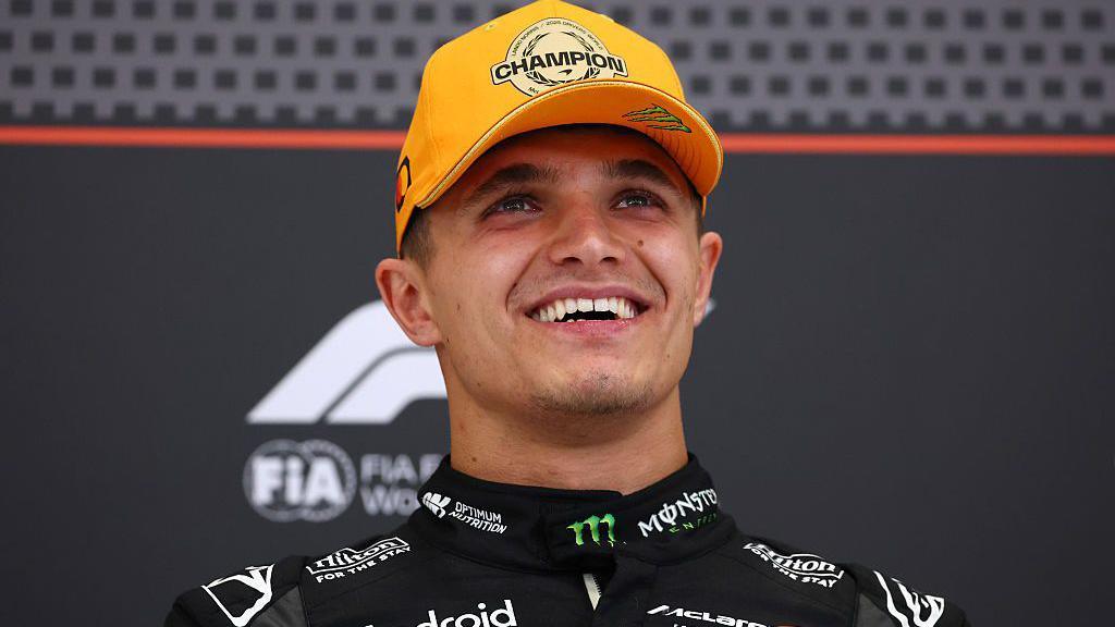 lando norris in F1 kit celebrating