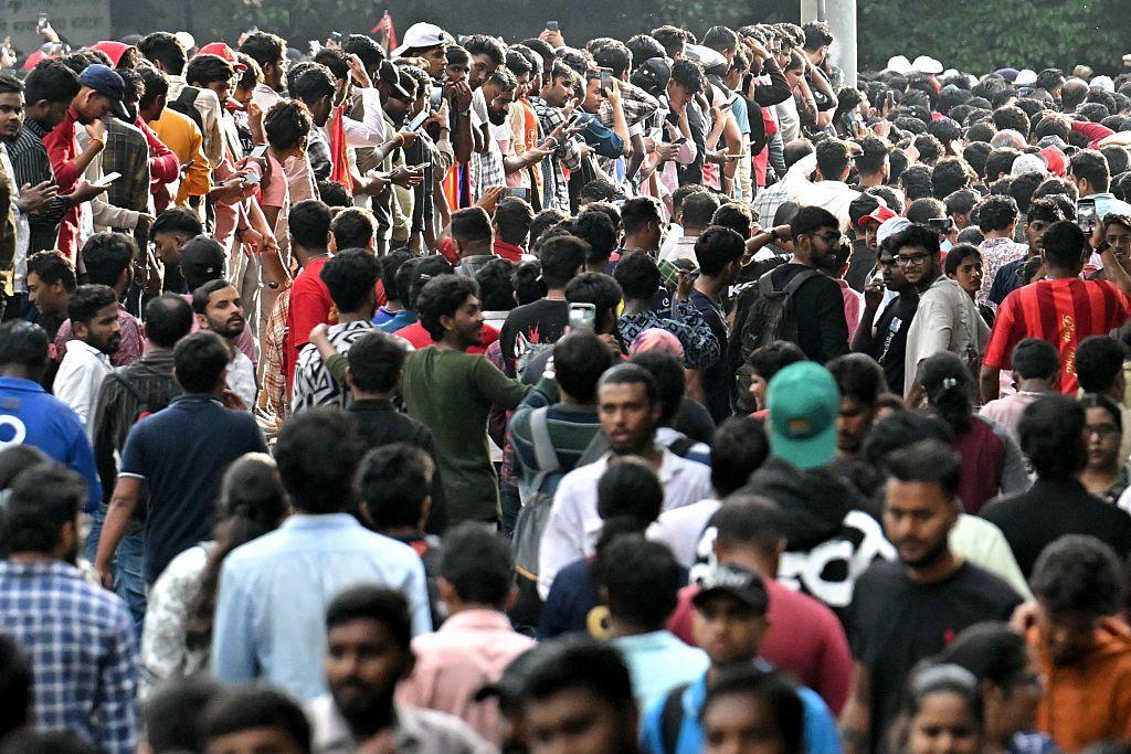 Fans gather to greet the players of Royal Challengers Bengaluru (RCB) outside Chinnaswamy Stadium in Bengaluru on June 4, 2025.