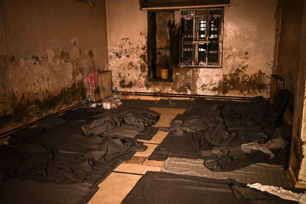 A picture shows a prison cell with blankets and makeshift beds on the floor, in the basement of the Syrian General Security Directorate Branch 251, also known as Al-Khatib branch