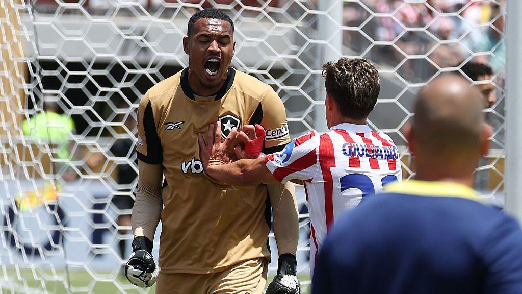 John Victor Maciel Furtado celebrates after making a save against Atletico Madrid
