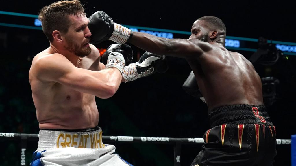 Lawrence Okolie punches his opponent David Light