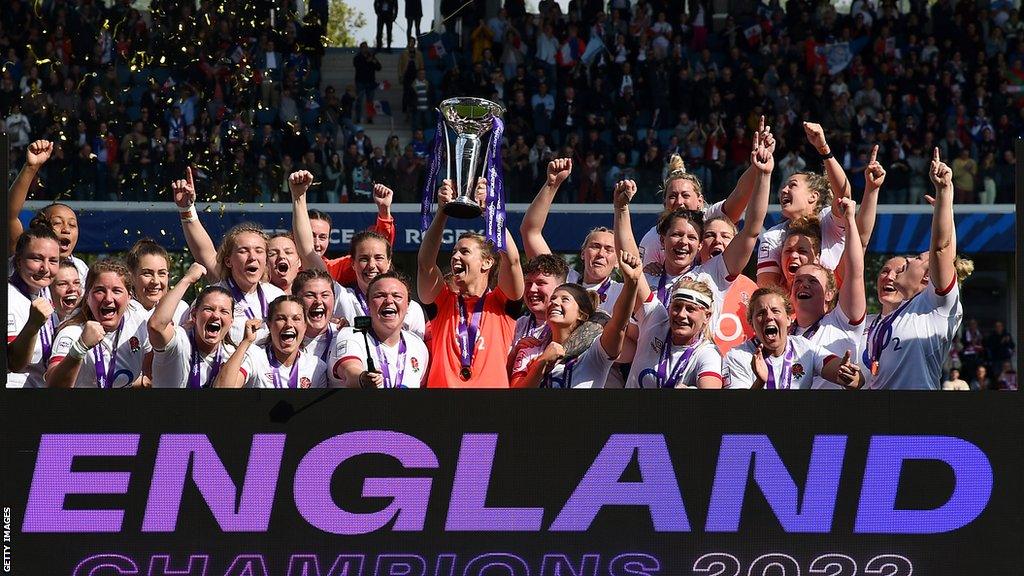 Sarah Hunter raises the Women's Six Nations trophy, celebrating with her England team-mates