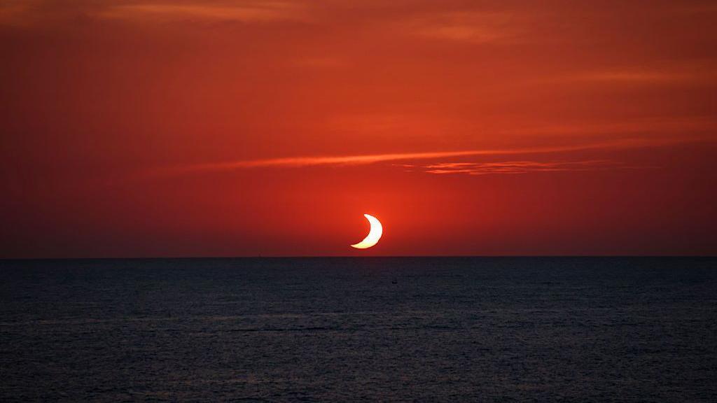 View during the total solar eclipse sunset on the Mediterranean sea in Port de Soller, Mallorca, Spain.