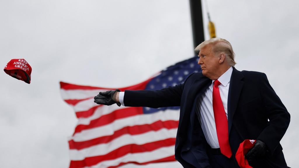 President Trump throws MAGA hat during Michigan campaign