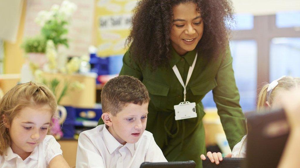 Teacher and children in a school classroom