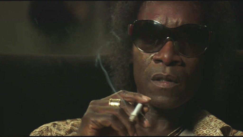 Don Cheadle as Miles Davis