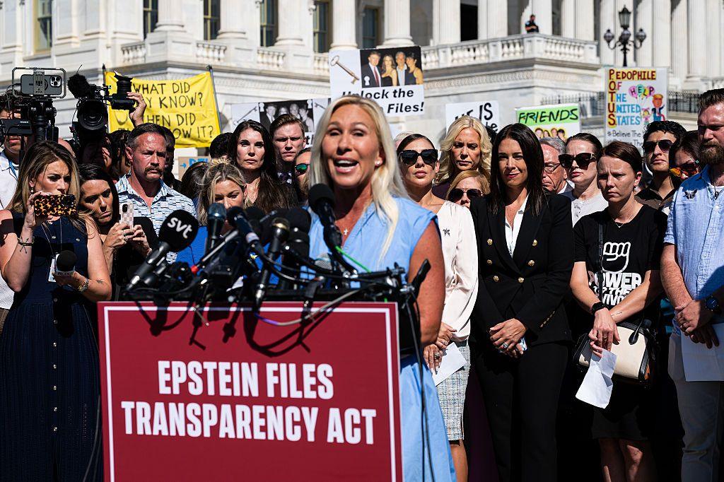 Majorie Taylor Greene speaks at a podium in front of the US Capitol
