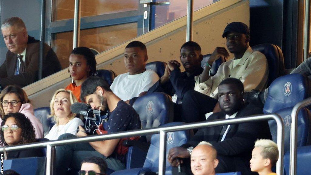 Kylian Mbappe watches Saturday's game from the stands