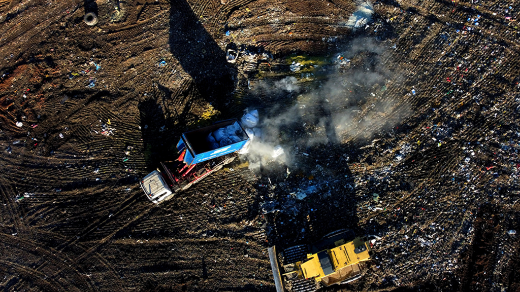 Aerial shot of two lorries operating on a landfill site