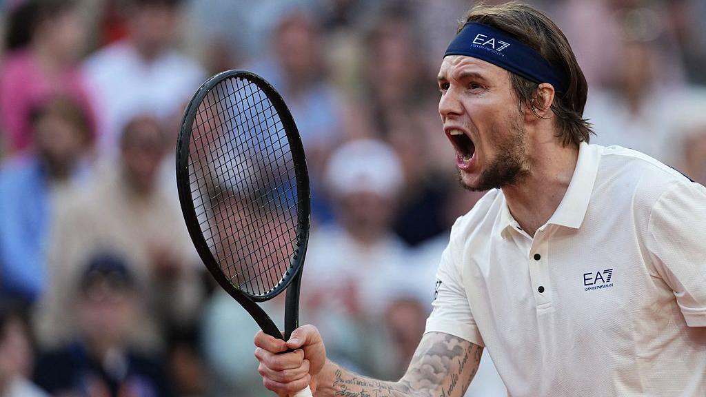 Alexander Bublik celebrates winning a point at the French Open