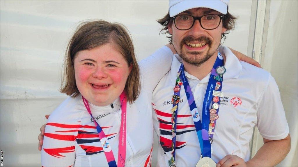 Cyclists Ella Curtis and Niall Guite wearing their Special Olympics medals around their necks