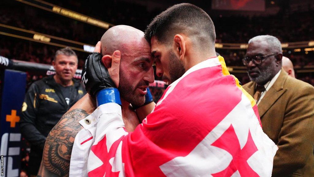 Ilia Topuria embraces Alexander Volkanovski after his victory at UFC 298