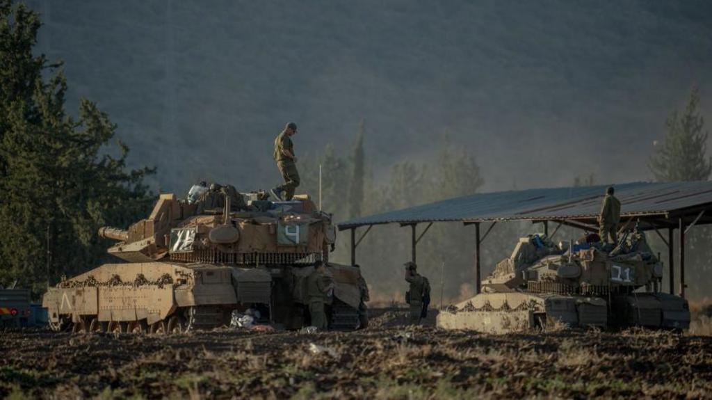 Israeli tanks and APC's gather by the Israeli - Lebanese border on September 30, 2024