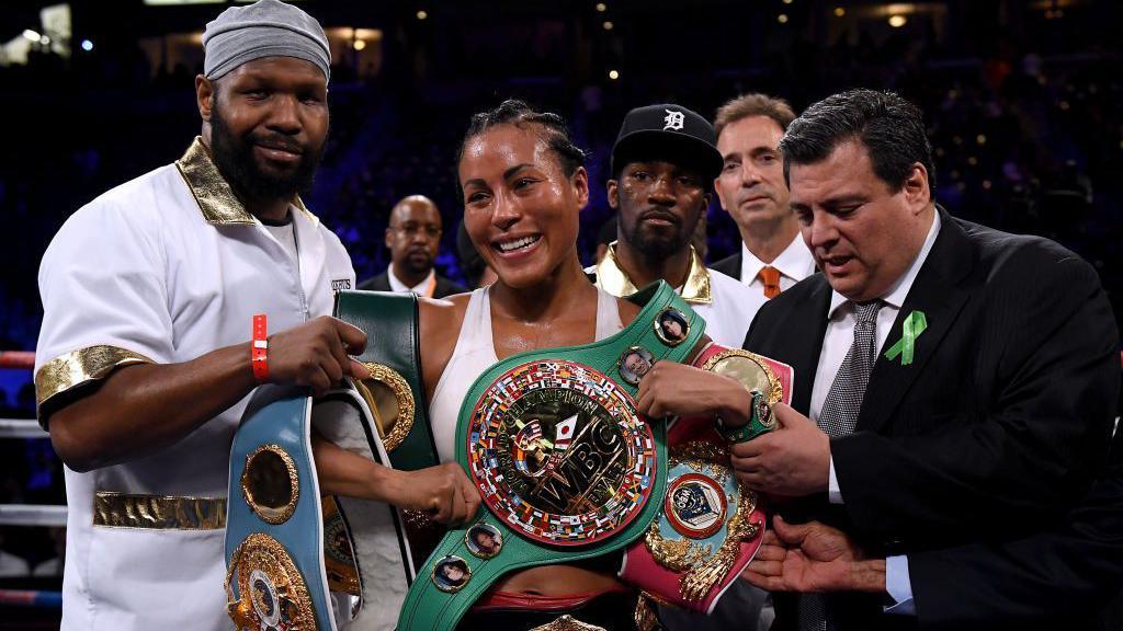Cecilia Braekhus poses with belts
