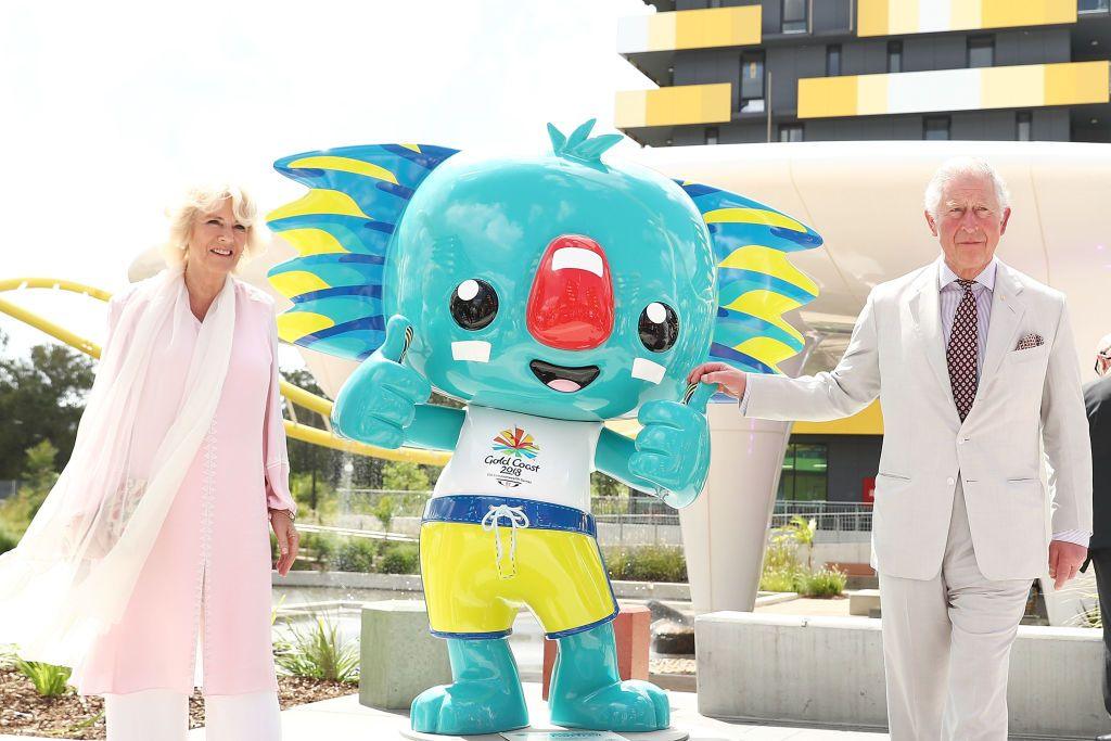 Queen Camilla and King Charles standing next to the 2018 Commonwealth games mascot