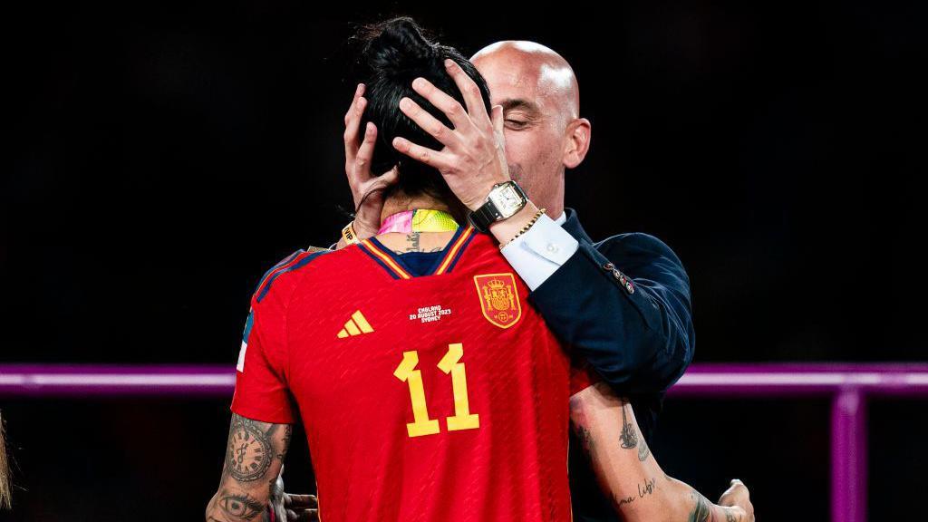 President of the Royal Spanish Football Federation Luis Rubiales (right) kisses Jennifer Hermoso