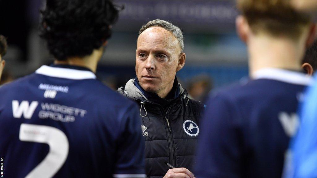 Larry MacAvoy stands preparing to deliver instructions to his squad