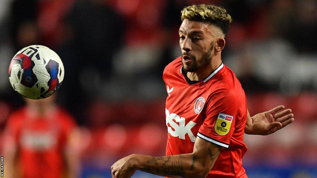 Macauley Bonne in action for Charlton, attempting to control a high bouncing ball