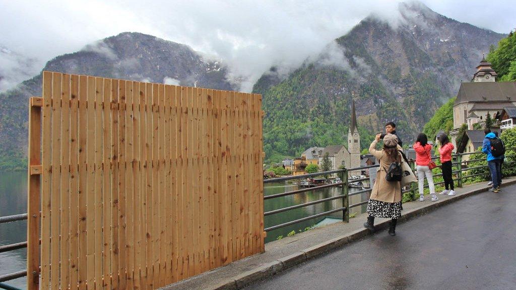 Wooden fence with backdrop of Austrian town of hallstatt