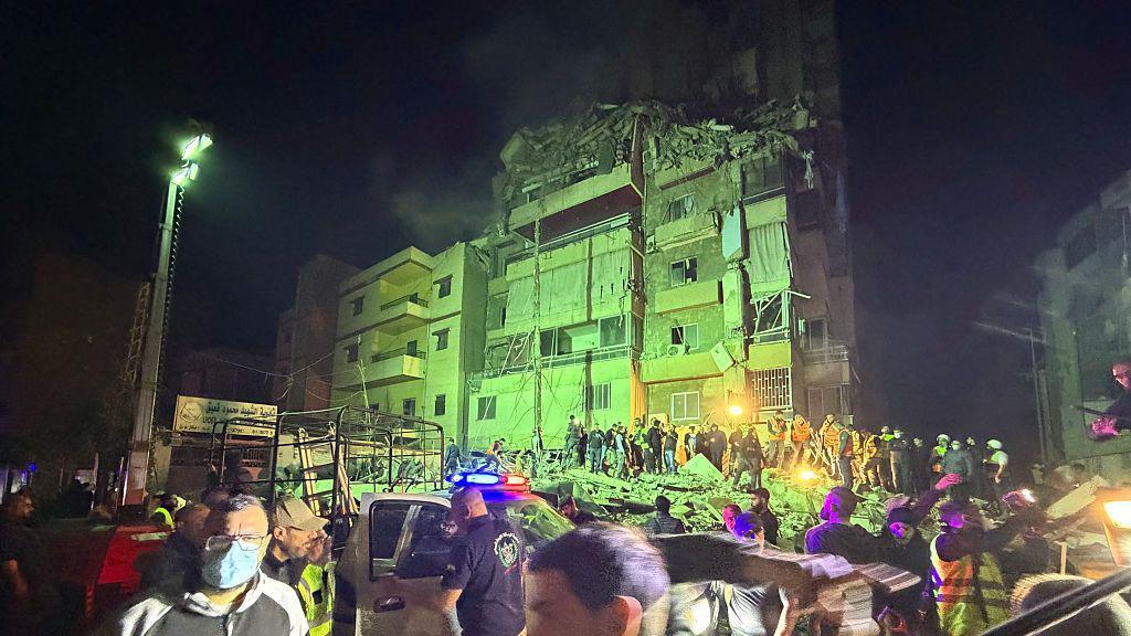 People gather at the site of an Israeli airstrike that targeted Beirut's southern suburbs Haret Hreik neighborhood on May 6, 2026