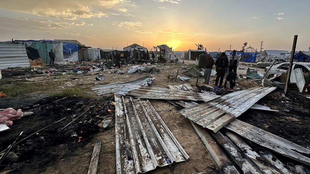 People inspect the site of an Israeli strike in the refugee camp of al-Mawasi in southern Gaza on 18 March