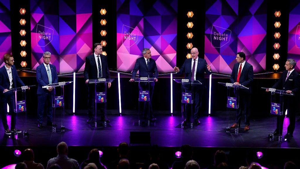The leaders on stage during the debate