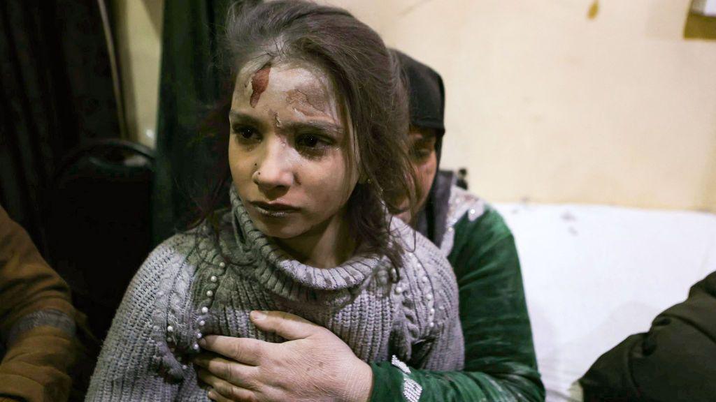 A young girl with an injured head, covered in dust. 