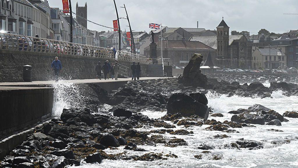People walking on Portstewart promenade in Northern Ireland.