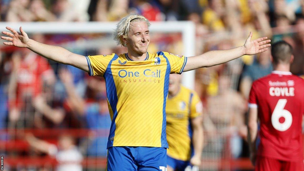 Mansfield's Aaron Lewis with his arms outstretched after scoring his wonder goal against Accrington