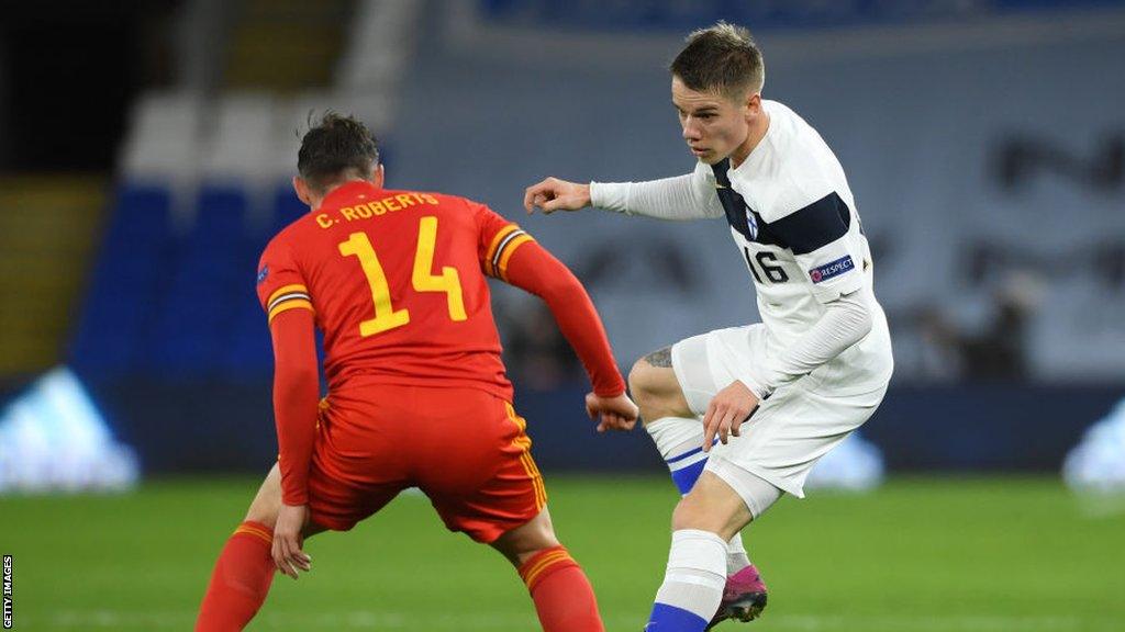 Finland player Robert Taylor takes on Wales player Connor Roberts